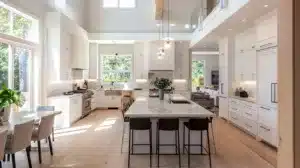Showing modern open concept kitchen ideas that showcases sleek shaker cabinets, bathed in natural light, highlighting the clean lines and minimalist aesthetic of contemporary living spaces.