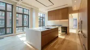 a sleek, modern kitchen featuring elegant shaker cabinets, abundant natural light streaming through large windows, and a minimalist design that embodies effortless sophistication.