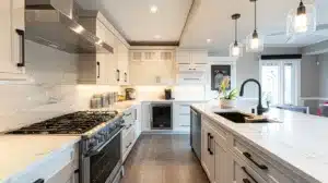 a sleek, modern kitchen features pristine shaker cabinets topped with gleaming countertops, illuminated by warm, ambient lighting that enhances the uncluttered, inviting atmosphere.